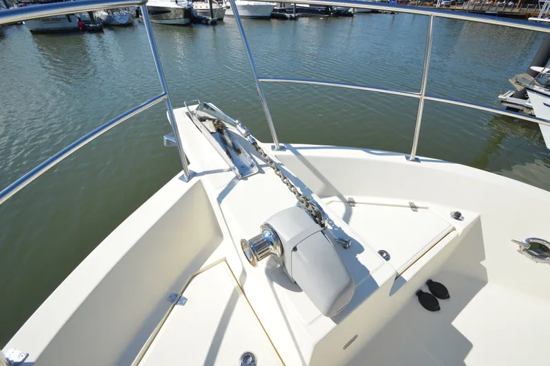 Slide: The Image of Bow view of 2012 North Pacific Yachts 43, featuring anchor and railing in marina setting. - 38