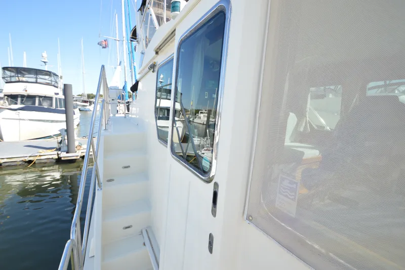 Slide: The Image of Side view of 2012 North Pacific Yachts 43, docked with visible railing and windows. - 35