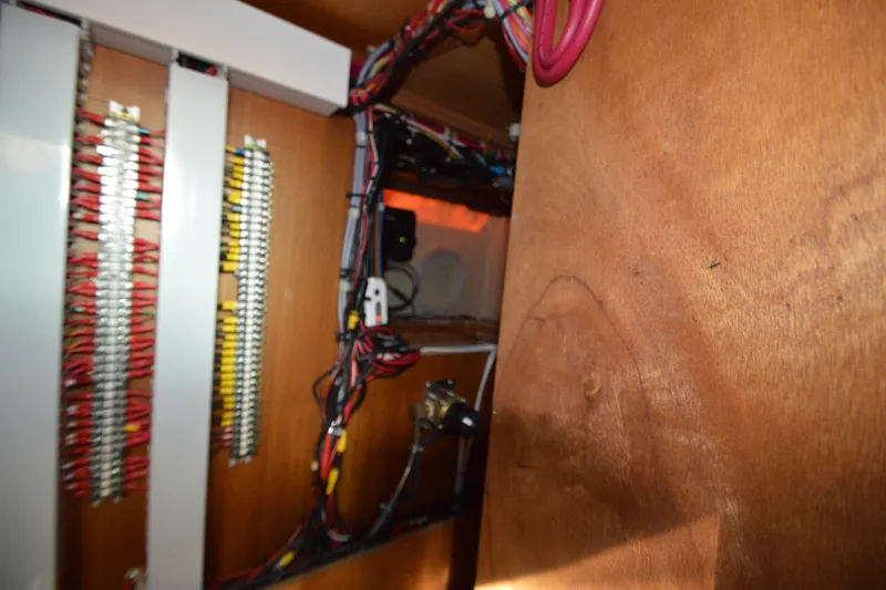 Slide: The Image of Electrical wiring inside a 2012 North Pacific Yachts 43, showcasing organized cables and panels. - 70