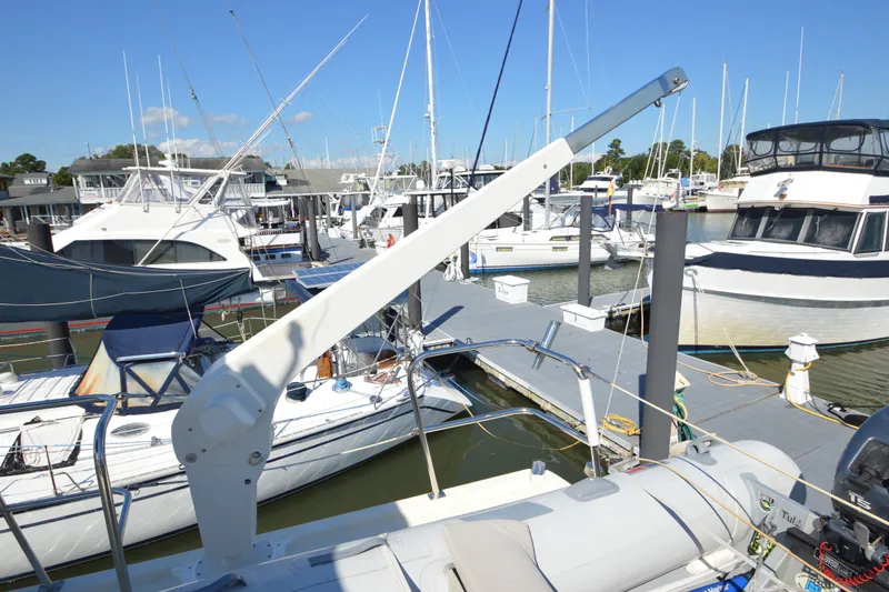Slide: The Image of 2012 North Pacific Yachts 43 docked at marina with other boats under clear blue sky. - 45