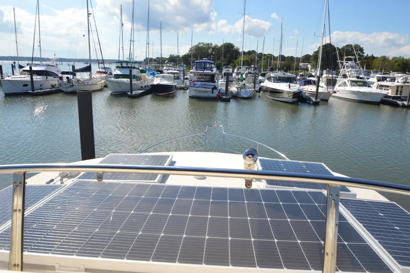Slide: The Image of North Pacific Yachts 43 (2012) with solar panels docked in a marina under a clear sky. - 43