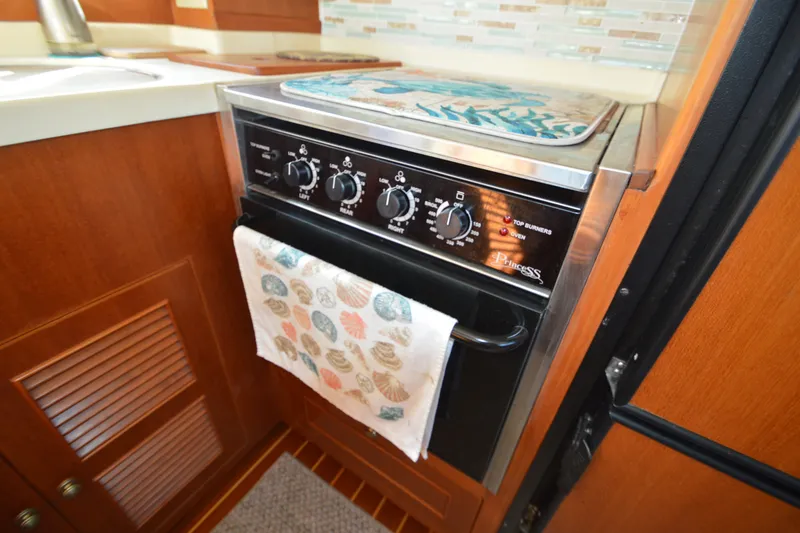 Slide: The Image of Galley kitchen in 2012 North Pacific Yachts 43 with stove and seashell towel. - 53