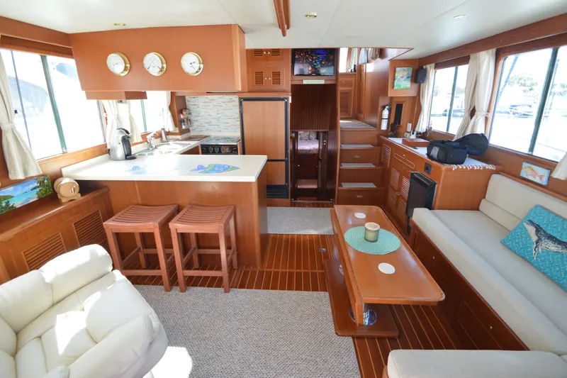 Slide: The Image of Luxurious interior of a 2012 North Pacific Yachts 43, featuring a cozy living area and kitchen. - 2
