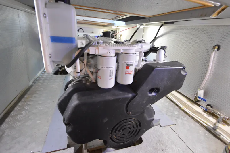 Slide: The Image of Engine room of 2012 North Pacific Yachts 43, showcasing mechanical components and filters. - 89