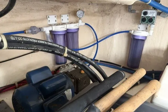 Slide: The Image of Engine room of a 2012 North Pacific Yachts 43, featuring filtration system and hoses. - 108