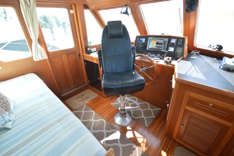 Slide: The Image of Interior of 2012 North Pacific Yachts 43, featuring helm station and seating area. - 7