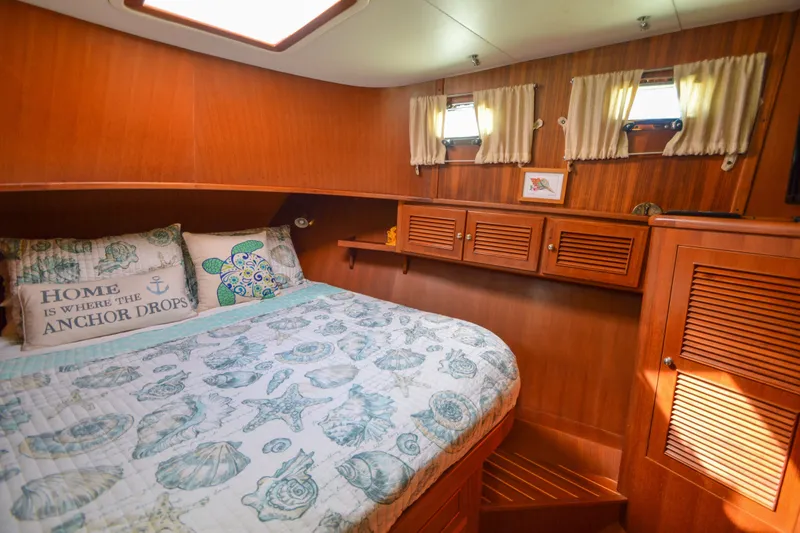 Slide: The Image of Cozy cabin interior of 2012 North Pacific Yachts 43 with nautical-themed bedding. - 74