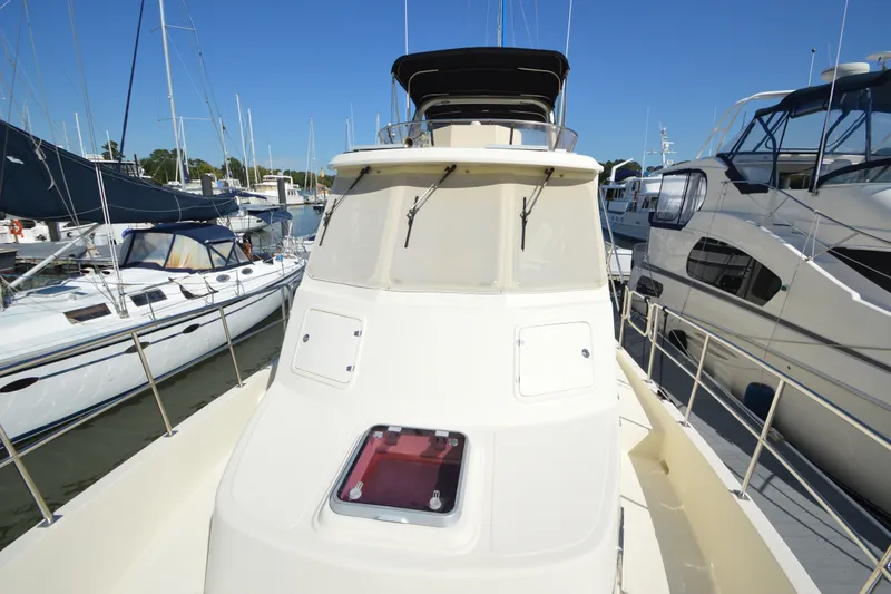 Slide: The Image of 2012 North Pacific Yachts 43 docked among sailboats and yachts on a sunny day. - 39