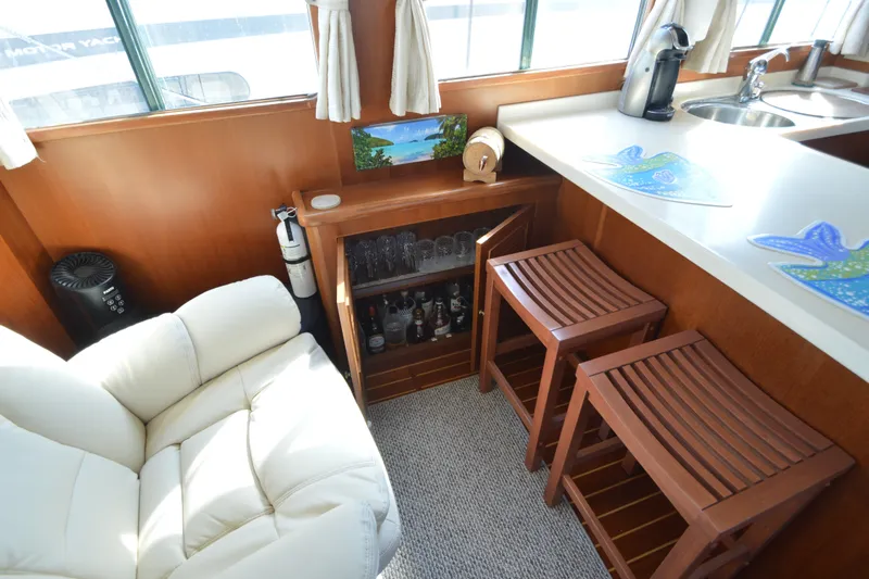 Slide: The Image of Luxurious interior of 2012 North Pacific Yachts 43 with bar, seating, and kitchenette. - 64