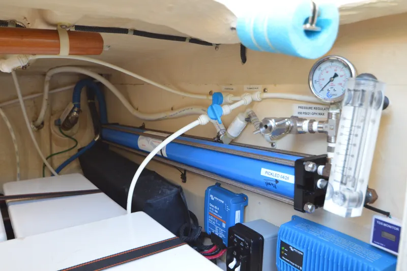 Slide: The Image of Engine room of 2012 North Pacific Yachts 43, featuring pressure regulator and filtration system. - 86