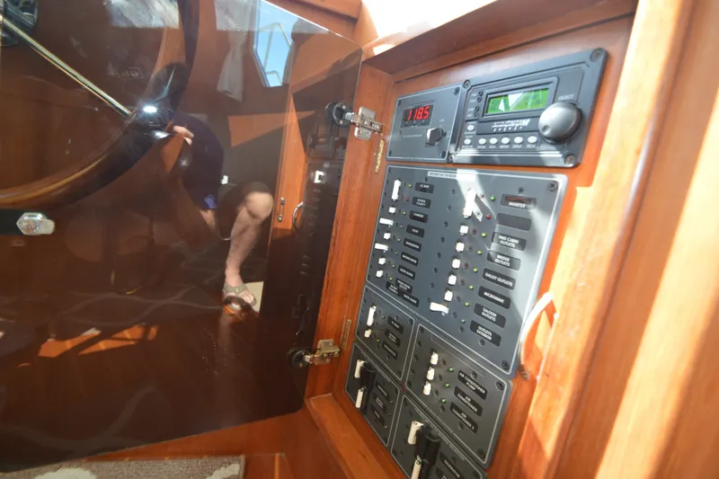 Slide: The Image of Electrical panel of a 2012 North Pacific Yachts 43, featuring control switches and gauges. - 69