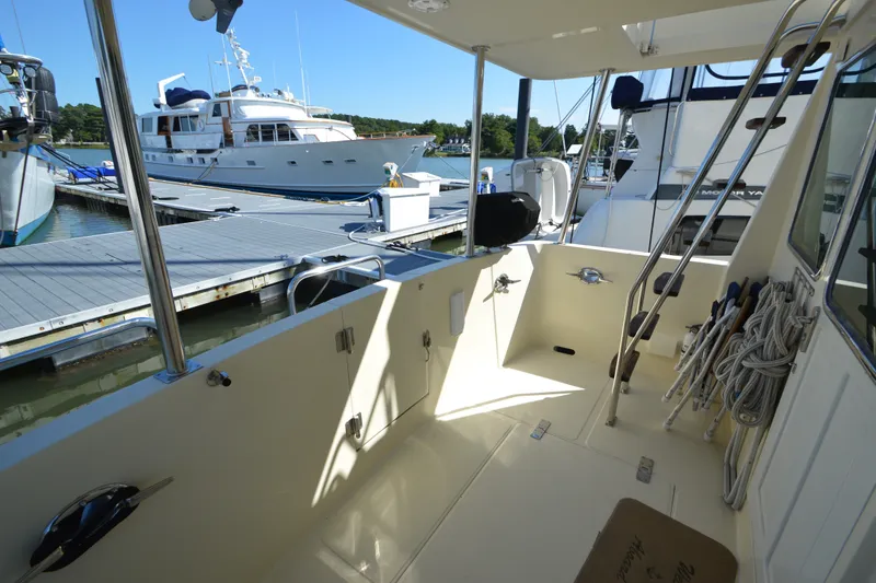 Slide: The Image of 2012 North Pacific Yachts 43 docked, showcasing spacious deck and marina view. - 50