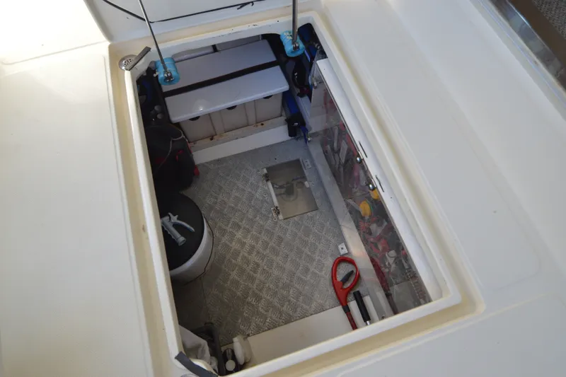 Slide: The Image of Engine compartment of 2012 North Pacific Yachts 43, featuring storage and equipment access. - 84