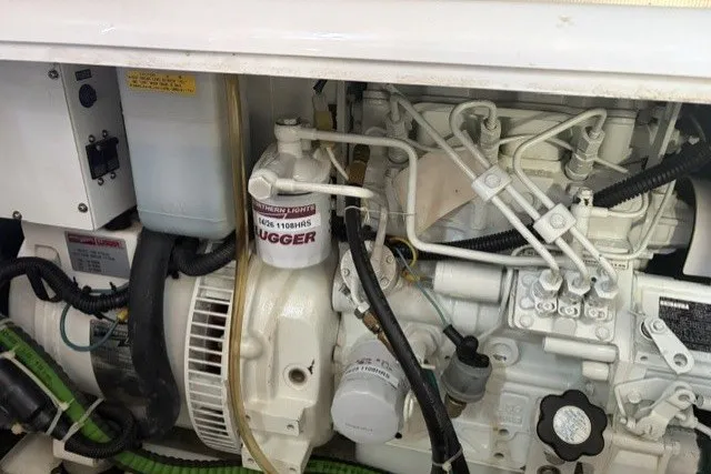 Slide: The Image of Engine compartment of a 2012 North Pacific Yachts 43, showcasing mechanical components and wiring. - 98