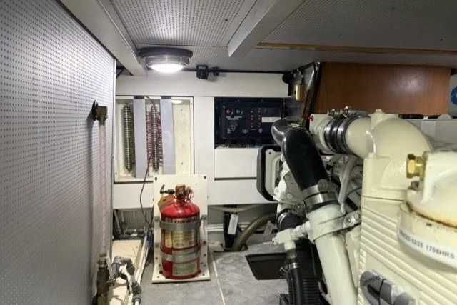 Slide: The Image of Engine room of 2012 North Pacific Yachts 43, featuring machinery and fire extinguisher. - 101