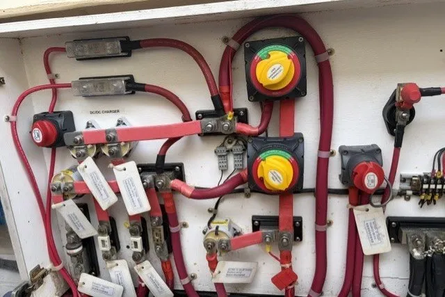 Slide: The Image of Electrical panel of a 2012 North Pacific Yachts 43, featuring wiring and switches. - 106