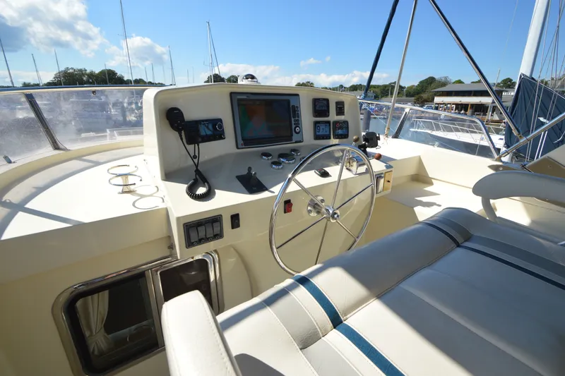 Slide: The Image of Cockpit of 2012 North Pacific Yachts 43, featuring steering wheel and navigation equipment. - 47