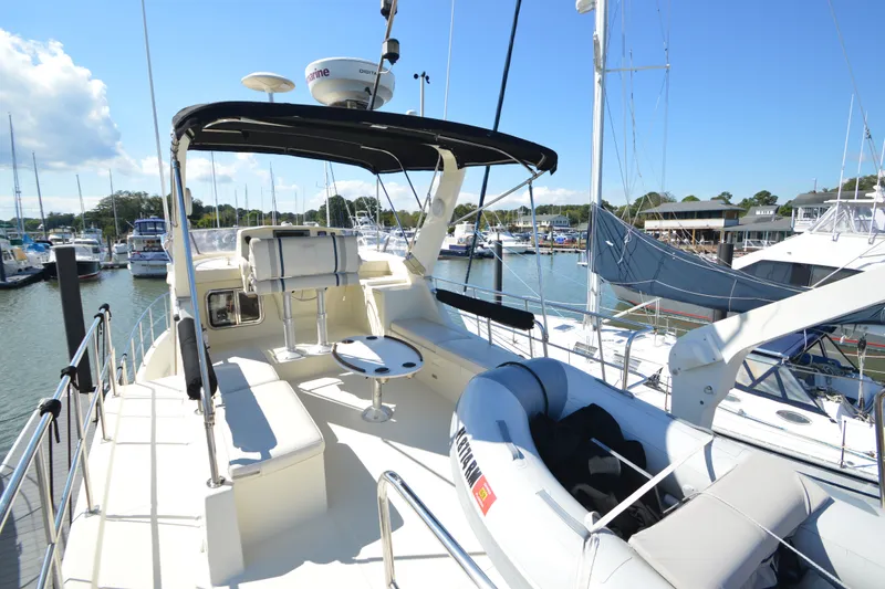 Slide: The Image of Flybridge view of 2012 North Pacific Yachts 43, docked in a sunny marina. - 40