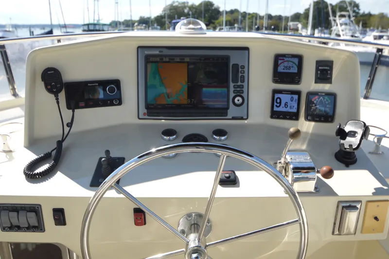 Slide: The Image of Helm of 2012 North Pacific Yachts 43 with navigation instruments and steering wheel. - 46