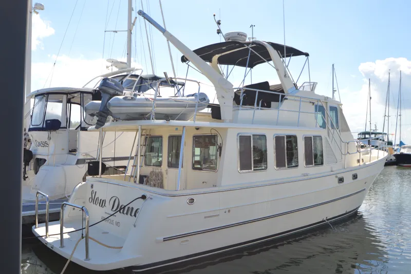 Slide: The Image of 2012 North Pacific Yachts 43 docked at marina, featuring spacious deck and modern design. - 28