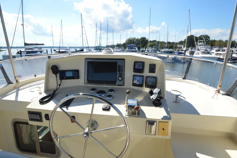 Slide: The Image of Helm of 2012 North Pacific Yachts 43, featuring navigation equipment and marina view. - 41