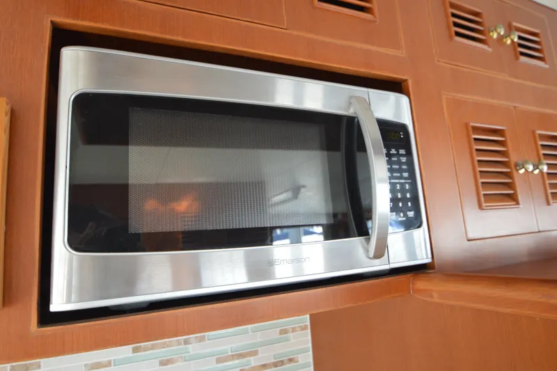 Slide: The Image of Built-in microwave in 2012 North Pacific Yachts 43, set in wooden cabinetry. - 58