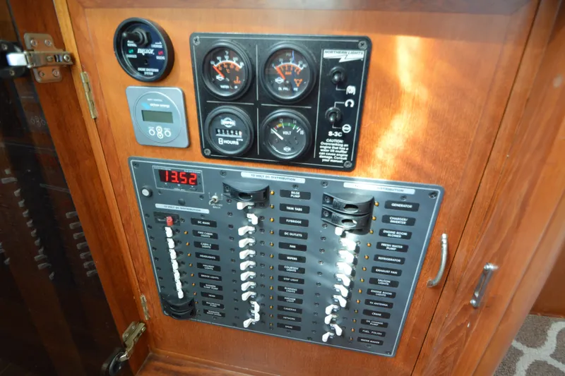 Slide: The Image of Electrical control panel on a 2012 North Pacific Yachts 43, featuring gauges and switches. - 72