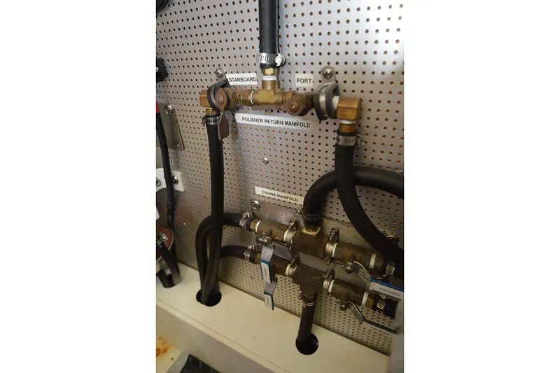 Slide: The Image of Engine manifold system on a 2012 North Pacific Yachts 43, featuring labeled hoses and valves. - 109