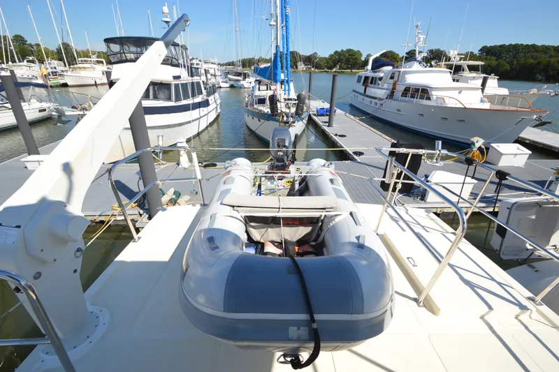 Slide: The Image of North Pacific Yachts 43, 2012 model, docked with inflatable boat on deck. - 32