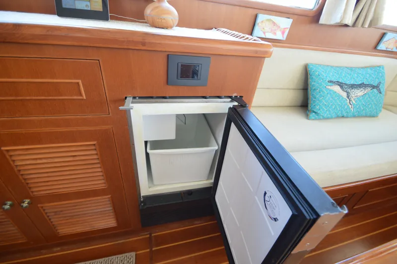 Slide: The Image of Interior of 2012 North Pacific Yachts 43 with open fridge and decorative pillow. - 59