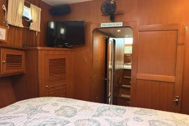 Slide: The Image of Interior of 2012 North Pacific Yachts 43, featuring wood paneling and a cozy cabin. - 27