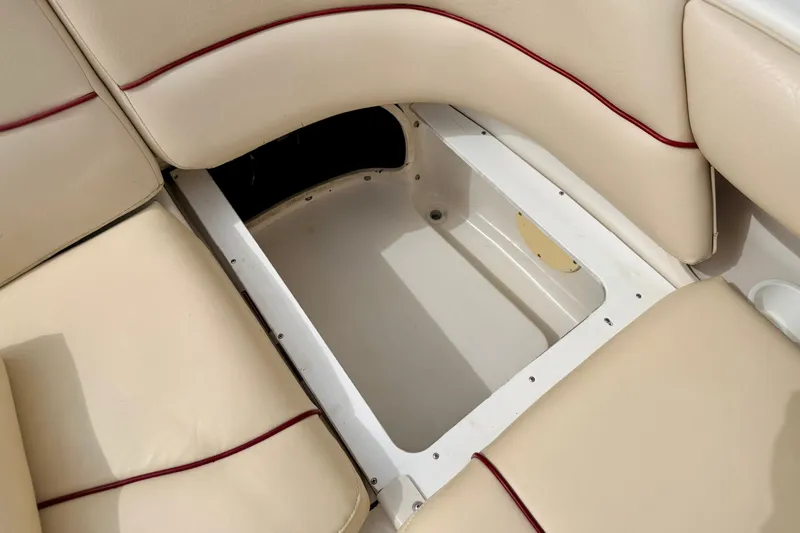 Slide: The Image of Storage compartment in 2000 Sea Ray 210 Sundeck boat with beige seating. - 27