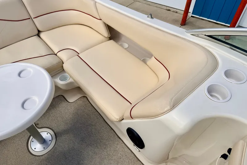 Slide: The Image of Luxurious seating area on a 2000 Sea Ray 210 Sundeck boat with cup holders. - 68