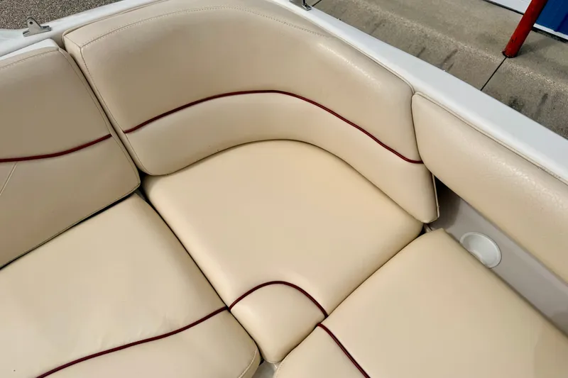 Slide: The Image of Cream leather seating on 2000 Sea Ray 210 Sundeck boat with red accents. - 26