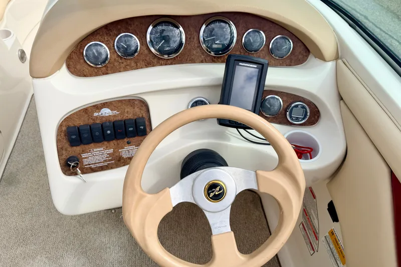 Slide: The Image of Dashboard of a 2000 Sea Ray 210 Sundeck boat with steering wheel and gauges. - 35