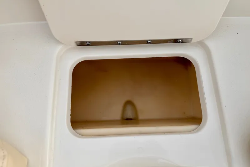 Slide: The Image of Storage compartment on a 2000 Sea Ray 210 Sundeck boat. - 54