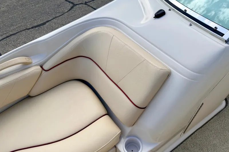Slide: The Image of Cream leather seating on 2000 Sea Ray 210 Sundeck boat, featuring red trim accents. - 65
