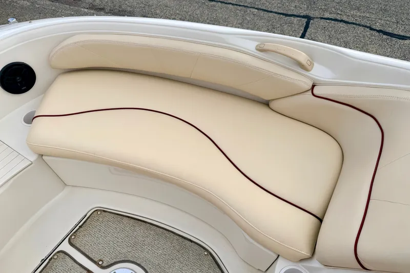 Slide: The Image of Cream leather seating on 2000 Sea Ray 210 Sundeck boat, featuring elegant red trim. - 51