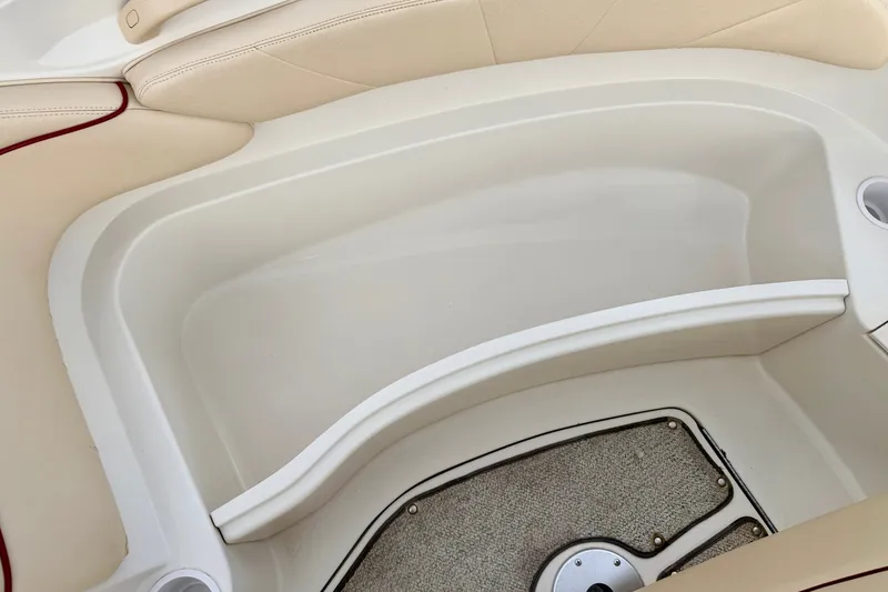 Slide: The Image of Interior seating area of a 2000 Sea Ray 210 Sundeck boat, featuring beige upholstery. - 50