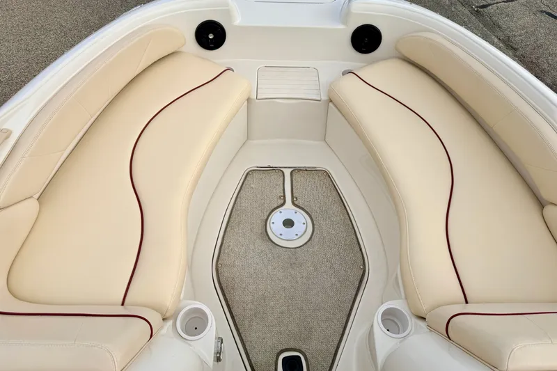 Slide: The Image of Interior view of a 2000 Sea Ray 210 Sundeck boat with beige seating. - 48