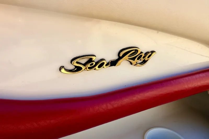 Slide: The Image of Gold "Sea Ray" logo on a 2000 Sea Ray 210 Sundeck boat with red trim. - 70