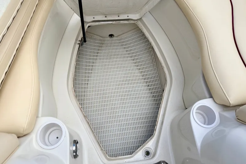 Slide: The Image of Interior of 2000 Sea Ray 210 Sundeck boat with beige seating and cup holders. - 61