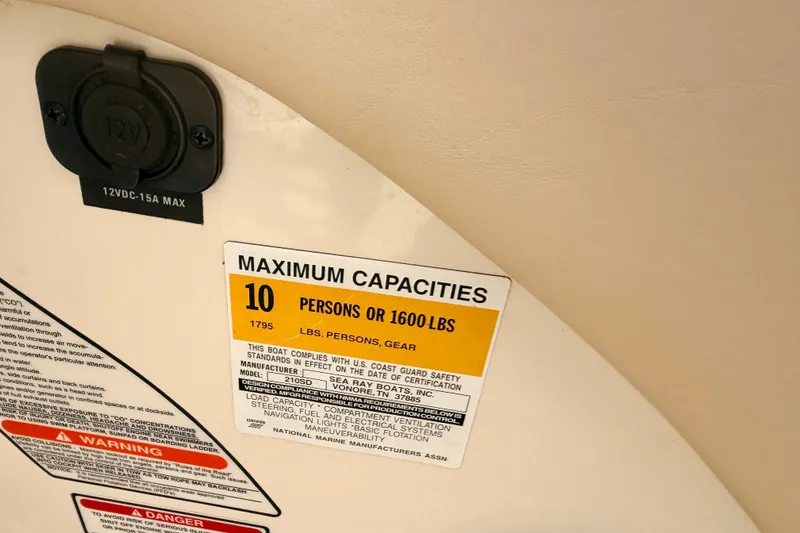 Slide: The Image of Sea Ray 210 Sundeck 2000 capacity label, 10 persons or 1600 lbs, safety compliance. - 40
