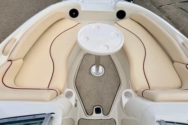 Slide: The Image of Luxurious seating area on a 2000 Sea Ray 210 Sundeck boat with a central table. - 56