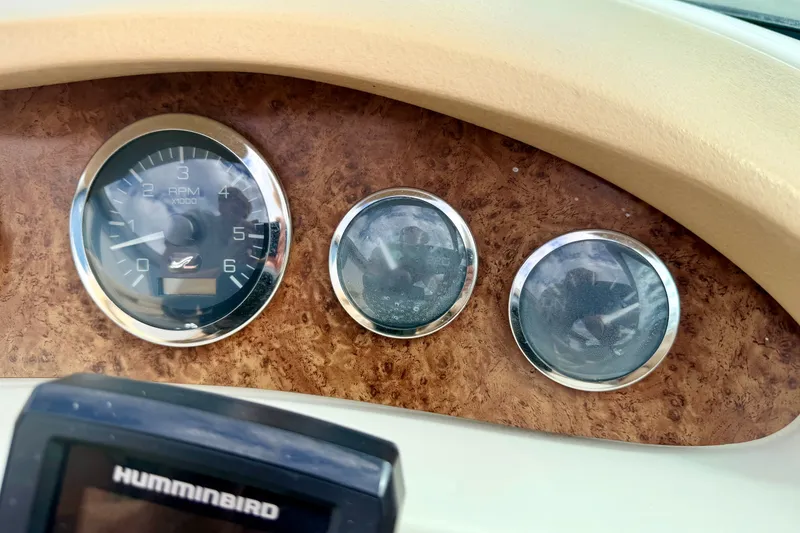 Slide: The Image of Dashboard of a 2000 Sea Ray 210 Sundeck boat with gauges and Humminbird device. - 37