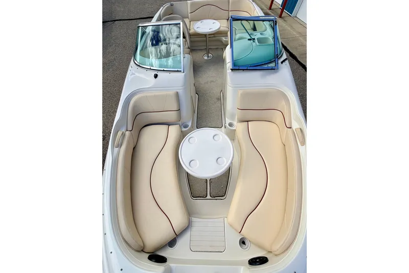 Slide: The Image of 2000 Sea Ray 210 Sundeck interior with beige seating and round table. - 64