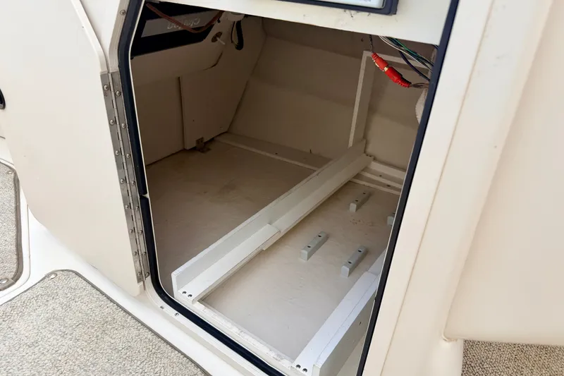 Slide: The Image of Storage compartment inside a 2000 Sea Ray 210 Sundeck boat, showing interior details. - 59
