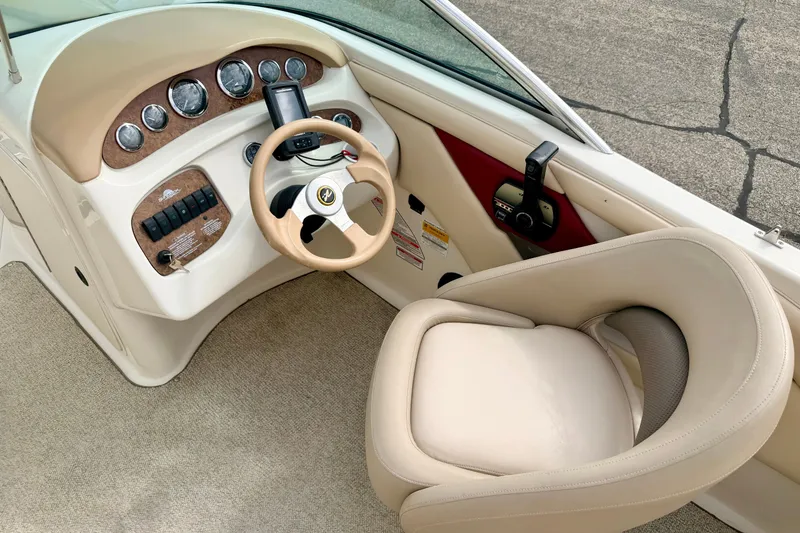 Slide: The Image of Interior view of a 2000 Sea Ray 210 Sundeck boat cockpit with steering wheel and controls. - 34