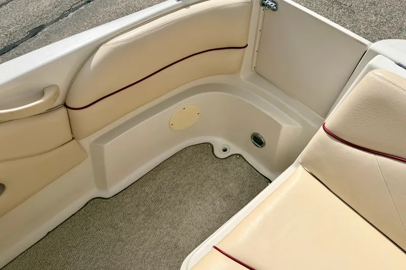 Slide: The Image of Interior seating of 2000 Sea Ray 210 Sundeck boat with beige upholstery. - 25