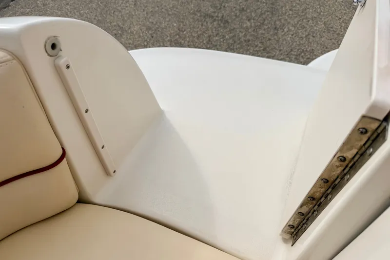 Slide: The Image of Interior detail of a 2000 Sea Ray 210 Sundeck boat, featuring beige seating and a white panel. - 23